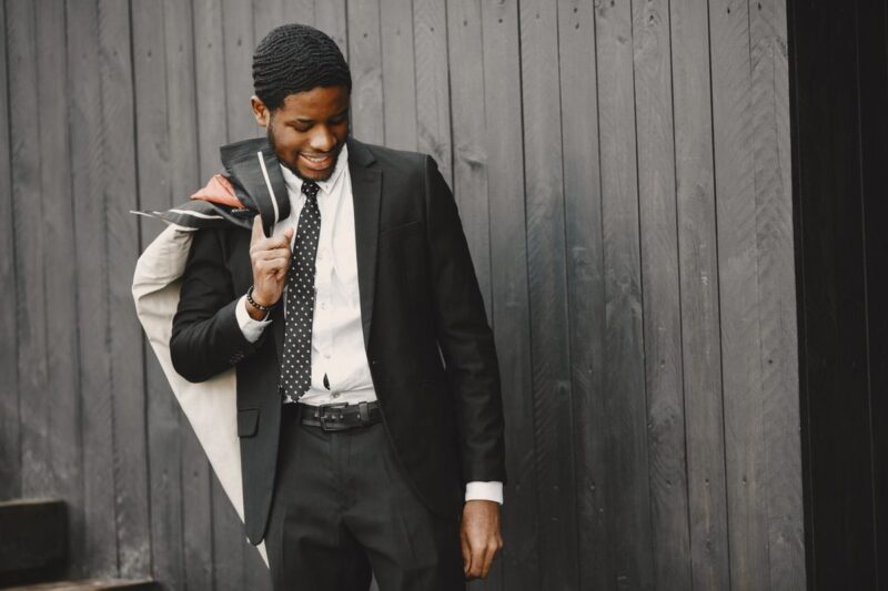 Man in a well-fitted dark suit looking sharp for celebrity menswear style