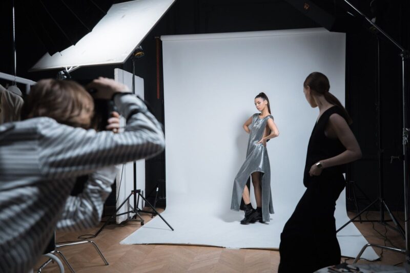 Celebrity photoshoot in a studio with a model, photographer and lighting equipment