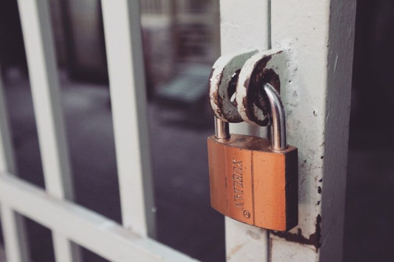 Close-up of a padlock on a metal gate