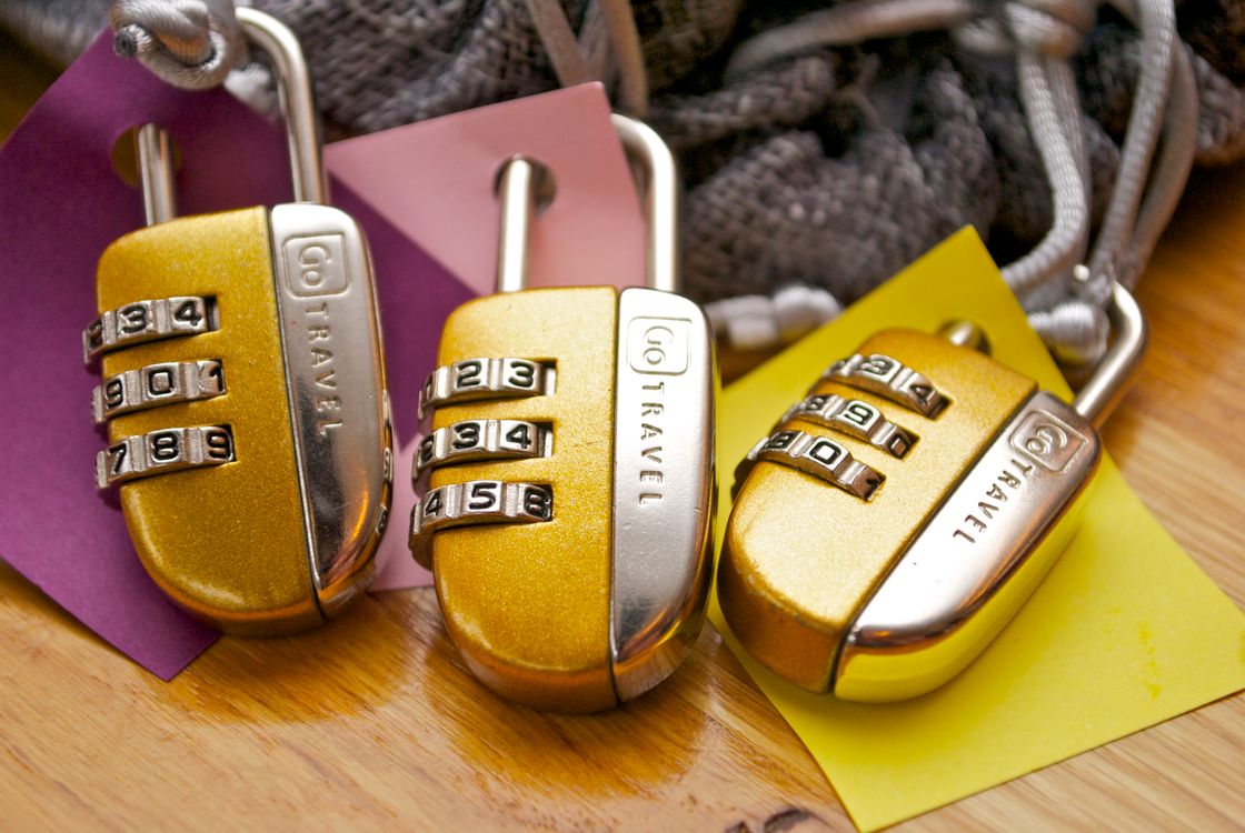 Three combination padlocks with colourful tags